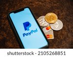 Small photo of Ufa, Russia - January 12, 2022: Paypal payment system accepts bitcoin and other cryptocurrencies. Bitcoin along with bank cards. High quality photo