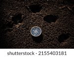Small photo of The compass lies on the ground, the landmark to the north, the magnetic needle of the compass shows to the east, the directions of the world, the traces of animals. High quality photo