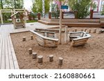 Children's playground for kids, a wooden ship buried in the sand, a place for outdoor games, a modern children's amusement park, a playground made of boards. High quality photo