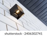 Small photo of Halogen lamp in street lamp, economical lighting, ice lantern on the wall of the house, spot lighting of the facade of a country house. High quality photo