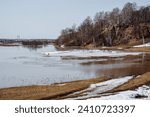 Small photo of Spring: flood on the river, flood season, flooding of the river in the countryside, flooded fields, early spring, thaw. High quality photo