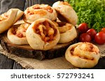 Pizza rolls with tomato sauce, mushrooms and cheese.