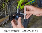 a hex key to repair a bicycle,installing a rear derailleur on a bicycle