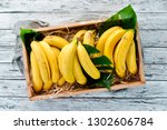 Fresh bananas in a wooden box. Top view. Free copy space.