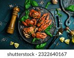 Small photo of Boiled Serrated mud crab and crayfish on black plate on black background. Seafood. Recipe.