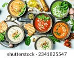 Small photo of Assortment of colorful vegetable soups: spinach, mushrooms, carrots and pumpkin. In a bowl. The concept of dietary nutrition. Top view.