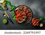 Small photo of Crayfish. Red boiled crawfishes in a bowl with rosemary and spices. On a dark background. Free space for the recipe.