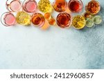 Assortment of alcoholic beverages: vodka, cognac, tequila, scotch, brandy and whiskey, grappa, liqueur, vermouth, tincture, rum. Strong alcoholic drinks. On a stone background.