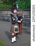 Small photo of Edinburgh, Scotland - June 30 2007: A bagpiper busking with the Great Highland bagpipe on the street.