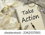 notepad on the desktop. text Take action