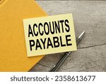 Small photo of ACCOUNTS PAYABLE. Business concept yellow sticker on a yellow notebook. text on note paper