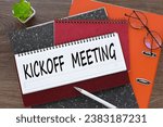 Small photo of Kickoff Meeting. diary with text on orange folder