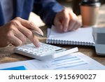 Close up businessman hand using calculator and working with  laptop calculate about finance accounting at coffeeshop outdor.finance accounting concept