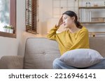 Depressed young Asian woman sitting on floor at home, Frustrated confused Sad female feels unhappy problem in personal life quarrel breakup with boyfriend or unexpected pregnancy concept