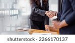 Small photo of Business handshake for teamwork of business merger and acquisition,successful negotiate,hand shake,two businessman shake hand with partner to celebration partnership and business deal concept