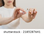 Small photo of Quit, stop smoking, addiction asian young woman, girl refusing cigarette, smoker quitting smoke, hand in broken, break tobacco. Quit bad habit, health care concept. Willpower lifestyle of people.