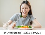 Small photo of Diet, Dieting asian young woman or girl use fork at broccoli on mix vegetables, green salad bowl, eat food is low fat good health. Nutritionist female, Weight loss for healthy person.