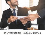 Small photo of Good job, asian manager man giving financial reward in an envelope, business letter extra salary to company employee, caucasian male worker office hand received premium bonus, getting cheque from boss
