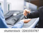 Small photo of Business car rental, sell or buy service, dealership hand of agent dealer, sale man giving auto key of vehicle to customer renter, buyer young woman receiving, client or tenant, transfer automobile.