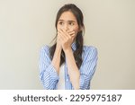 Small photo of Portrait of pretty brunette hair, disgust smell bad breath strong asian young woman shocked covering, close her mouth with hand, expression face disgusting, dislike odor. Isolated on white background.