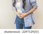 Small photo of Flatulence asian young woman intolerance hand in stomach ache, suffer from food poisoning, abdominal pain and colon problem, gastritis or diarrhoea when at home. Patient belly, abdomen or inflammation