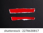 Small photo of Red ripped paper pieces isolated on a black background
