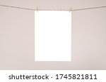 Small photo of A4 / A3 / 5x4" poster MOCKUP hung by string and pegs with pink background. White wooden frame ready to drop in poster artwork.. Perfect MOCKUP for artists and designers, print makers.