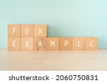 Small photo of Wooden blocks with "FOR EXAMPLE" text of concept.
