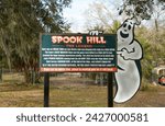 Small photo of Lake Wales, FL USA - February 13, 2024: Spook Hill is a hill in Florida where cars appear to roll up the hill.