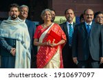 Small photo of New Delhi, India-1 February 2021Union Finance Minister Nirmala Sitharaman , MoS Finance Anurag Thakur with budget team shows iPad enveloped in red cover with a golden National emblem on it.