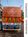 Small photo of New Delhi, India-Jan 25 2021: colorful back or Rear View of a truck. Most trucks are painted with religious motives, or safety reasons or hints like blow horn please. traditional art work on the truck