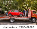 Small photo of New Delhi, India-March 6 2022: logistic vehicle carrying Antique Vintage Mini coper car on Road