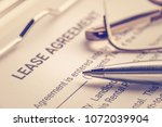 Small photo of Business legal document concept : Pen and glasses on a lease agreement form. Lease agreement is a contract between a lessor and a lessee that allow lessee rights to use of a property owned by lessor