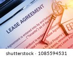 Small photo of Business lease agreement concept : Pen and keychain on a lease agreement form. Lease agreement is a contract between a lessor and a lessee that allow lessee rights to use of a property owned by lessor