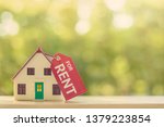 Small photo of House for rent concept : Model house with a paper tag with chain, depicts a payment for temporary use of a property owned by another owner, tenant unwilling to pay full price, avoid burden of upkeep.