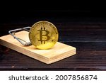 Mousetrap with bitcoin coin. Souvenir bitcoin coin in the form of bait.