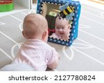 Baby looking in the mirror during tummy time