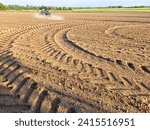 Small photo of Deep traces in the field bear witness to the farmers' tireless work