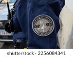 Small photo of France, Marseille - 27-01-2023: The GSP Sud logo sewn onto the sleeve of a policewoman's uniform in Marseille