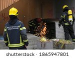 Small photo of Firefighters trying to cut trough venthole with grinder to get the smoke out of people's apartments. Translation: ''Firefighters Rescuers''