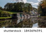 Small photo of a row of narrow boats on one of Dudley's many canals (or the cut as we know it) near the Stewponey in Stourton. with autumn colours in the trees and still reflective water bellow