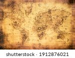 Vintage world map on an old stained parchment