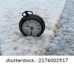 A Wind Up Watch In The Snow