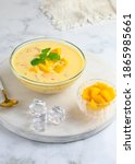 Small photo of A bowl of Mango sago, Hongkong dessert made from mango juice, jelly, sago pearl, evaporated milk and sweetened condensed milk. White background, Selective focus