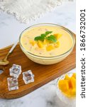 Small photo of A bowl of Mango sago, popular dessert made from mango juice, jelly, sago pearl, evaporated milk and sweetened condensed milk. Served cold, Selective focus