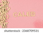 Small photo of Popular and modern baby boy fashion name CALEB in wooden English language capital letters spilling from a pile of letters on a red background pencil sketch