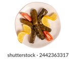 Small photo of Stuffed grape leaves with olive oil. Appetizer dishes. Stuffed stuffed leaves with meat isolated on white background. local name yaprak sarma. Top view