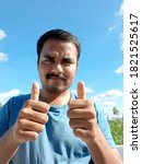 Small photo of Business Concept - Portrait Handsome Business man surrendering twofold thumb. Segregated on blue sky Background