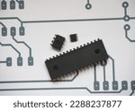 Small photo of Integrated circuits and microchip on electronic schema background.