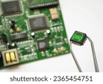 Small photo of Chips in automobile manufacturing. Inserting car brains. Printed circuit boards with chips. Electronic control and micro chip concept background.